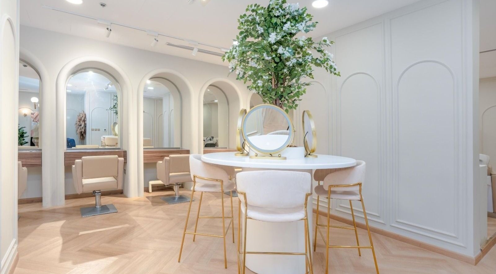 Elegant salon interior at La Beauté, Dubai, AE with stylish seating and lush decor.