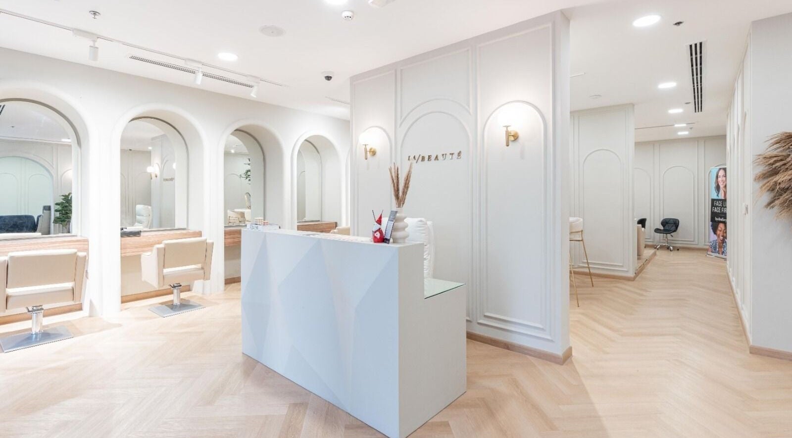 La Beauté's chic reception area in Dubai, AE, with plush seating and elegant decor.