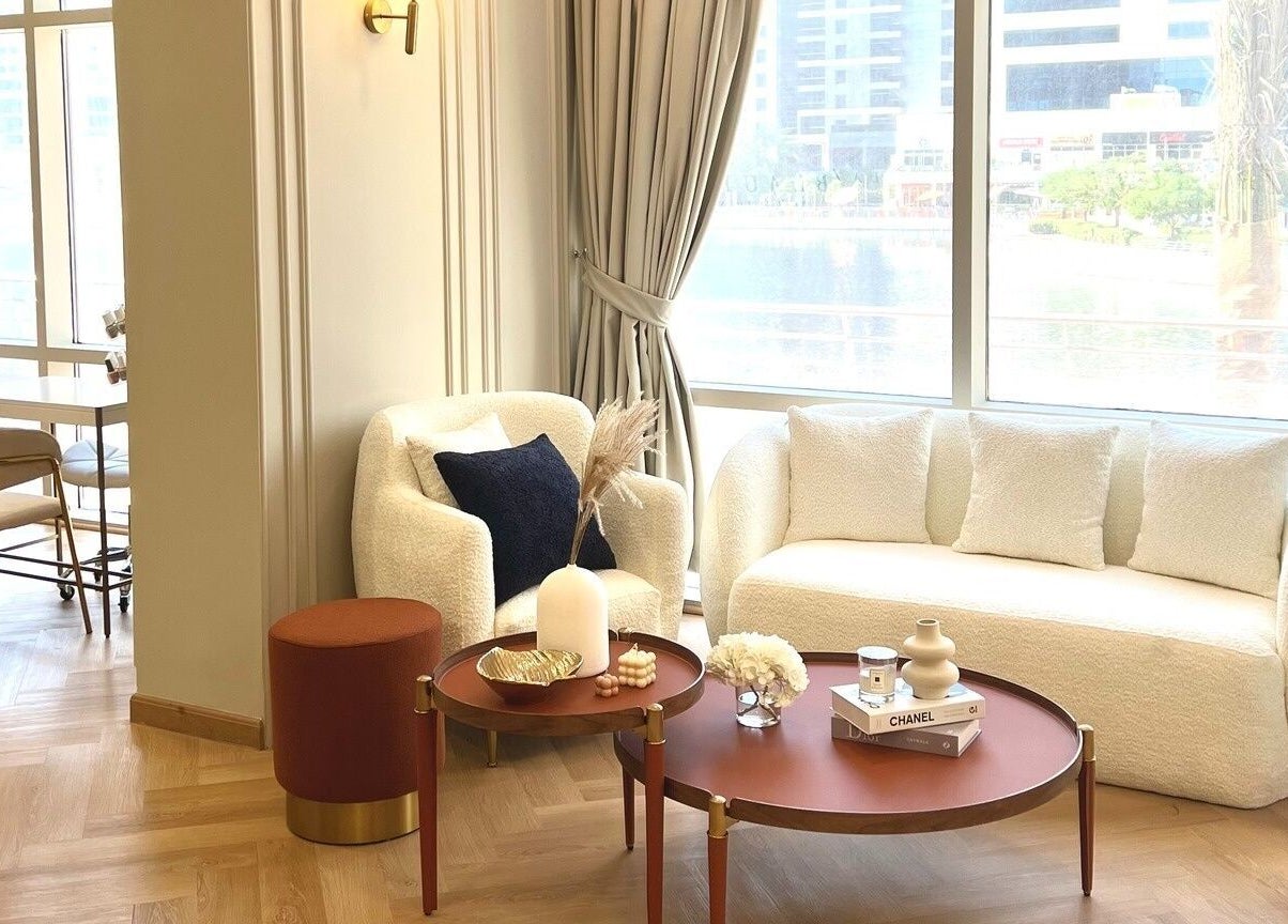 Relaxing seating area in La Beauté, Dubai, AE, featuring elegant sofas, tables, and decor.