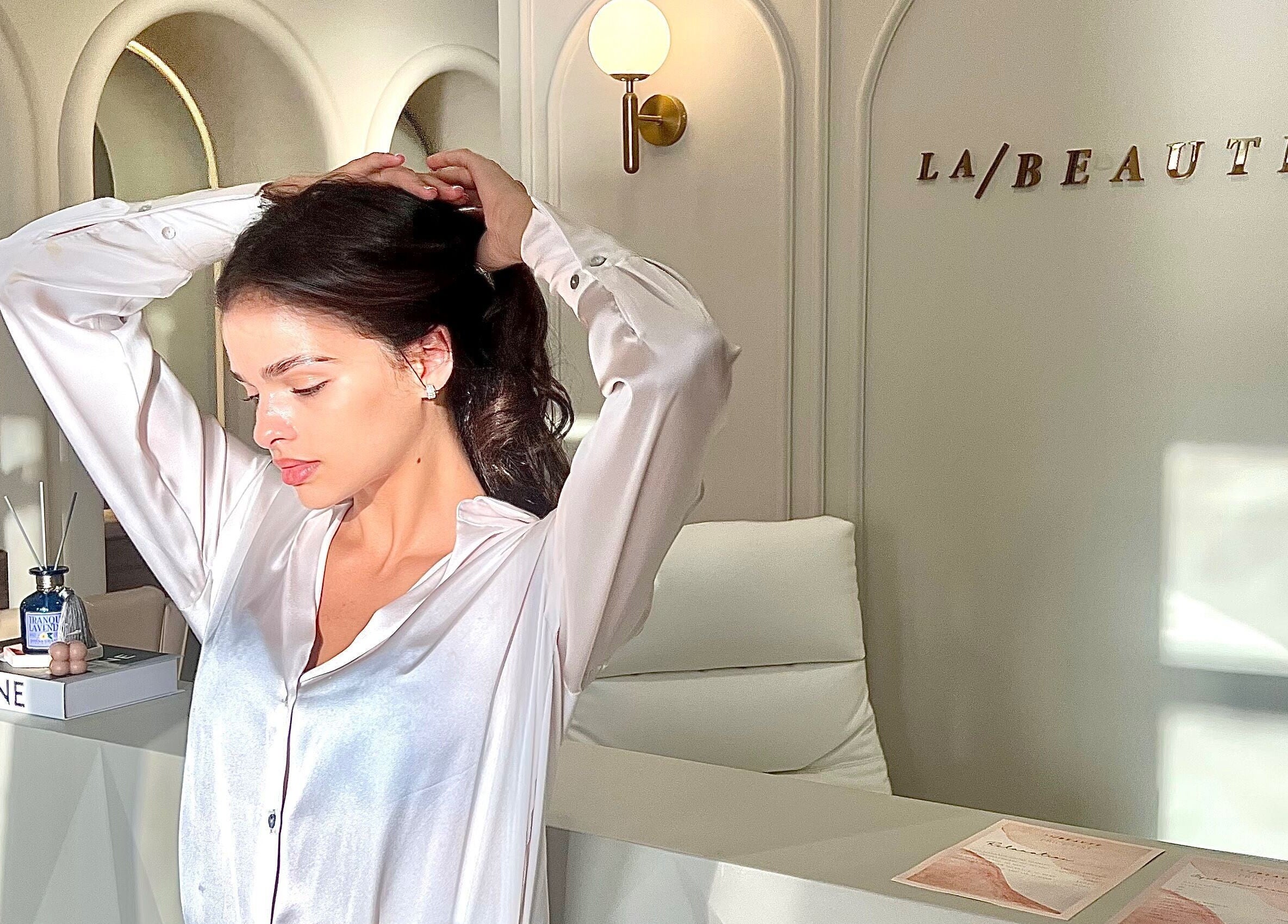 Woman at La Beauté front desk in Dubai, AE, showcasing elegance and beauty.