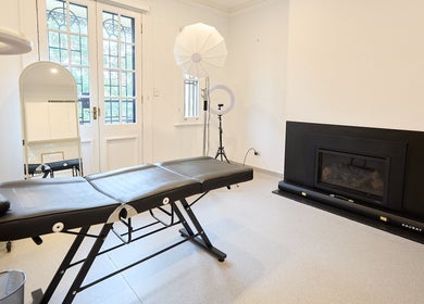 Modern treatment room at Angelina Samko, Bondi Junction, New South Wales, AU, with massage table and bright décor.