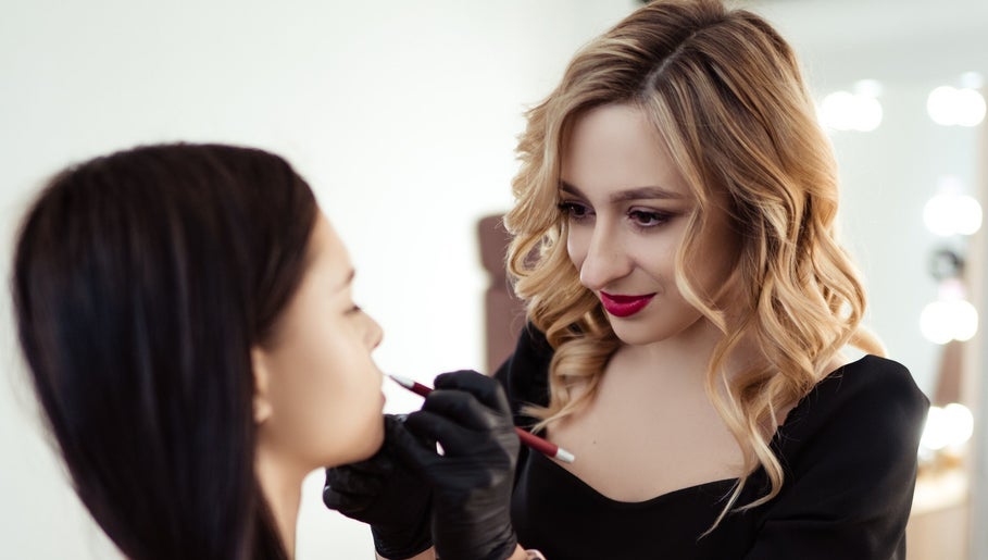 Makeup artist at Angelina Samko, Bondi Junction, New South Wales, AU applying lipstick.