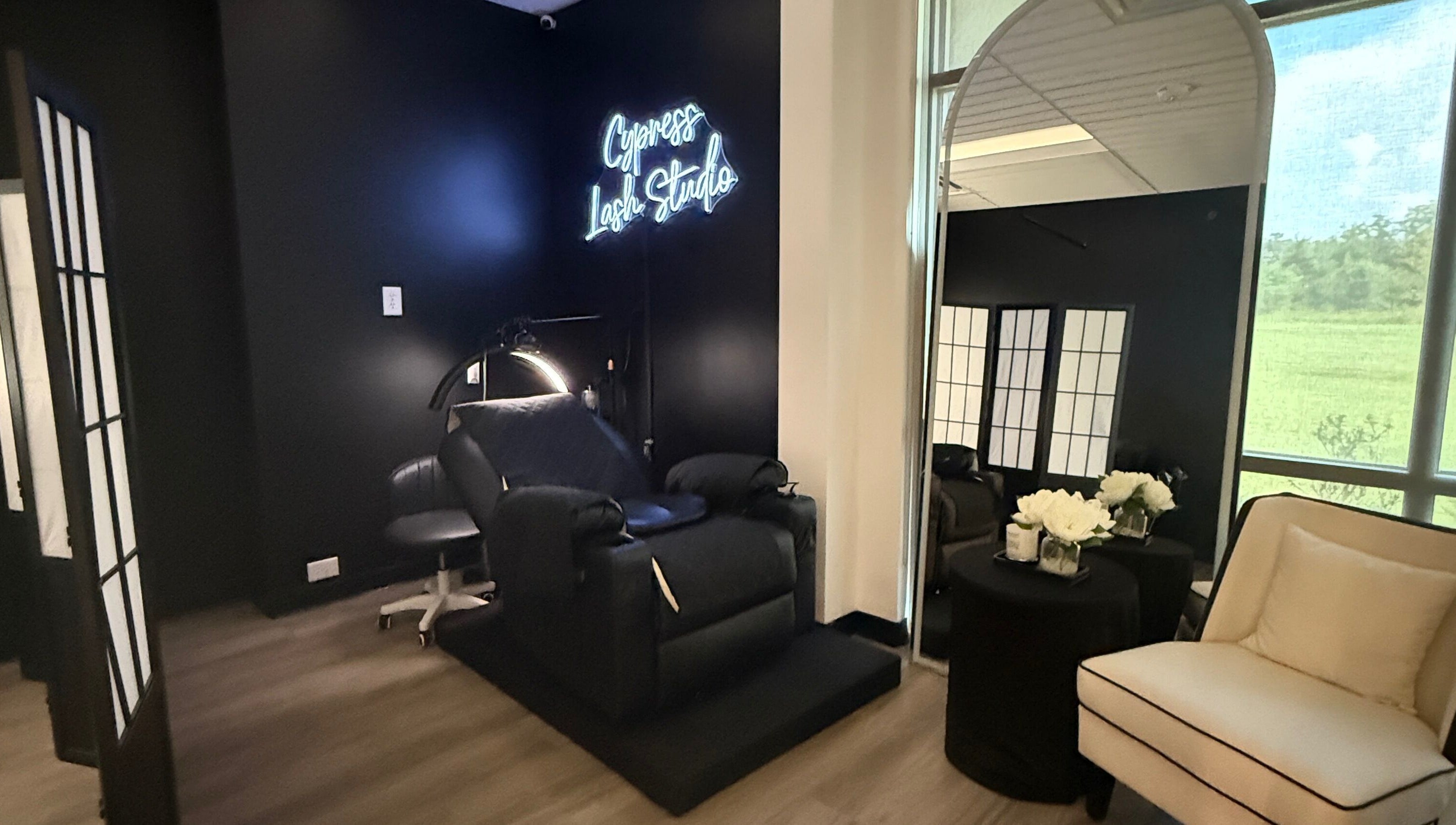 Sleek interior of Cypress Lash Studio in Cypress, Texas, US, featuring a plush chair and elegant decor.