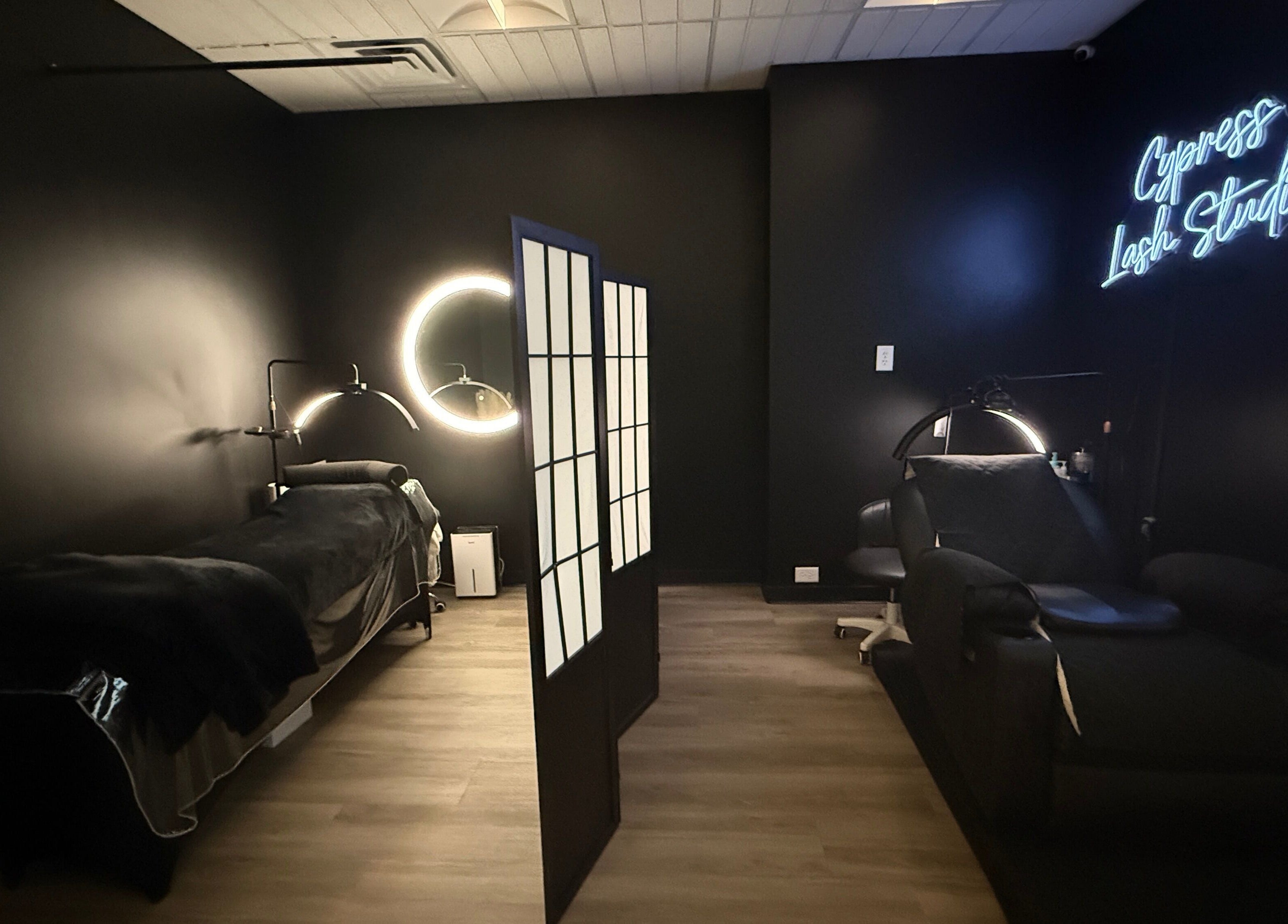 Modern styling room at Cypress Lash Studio, Cypress, Texas, US with neon signage and sleek decor.