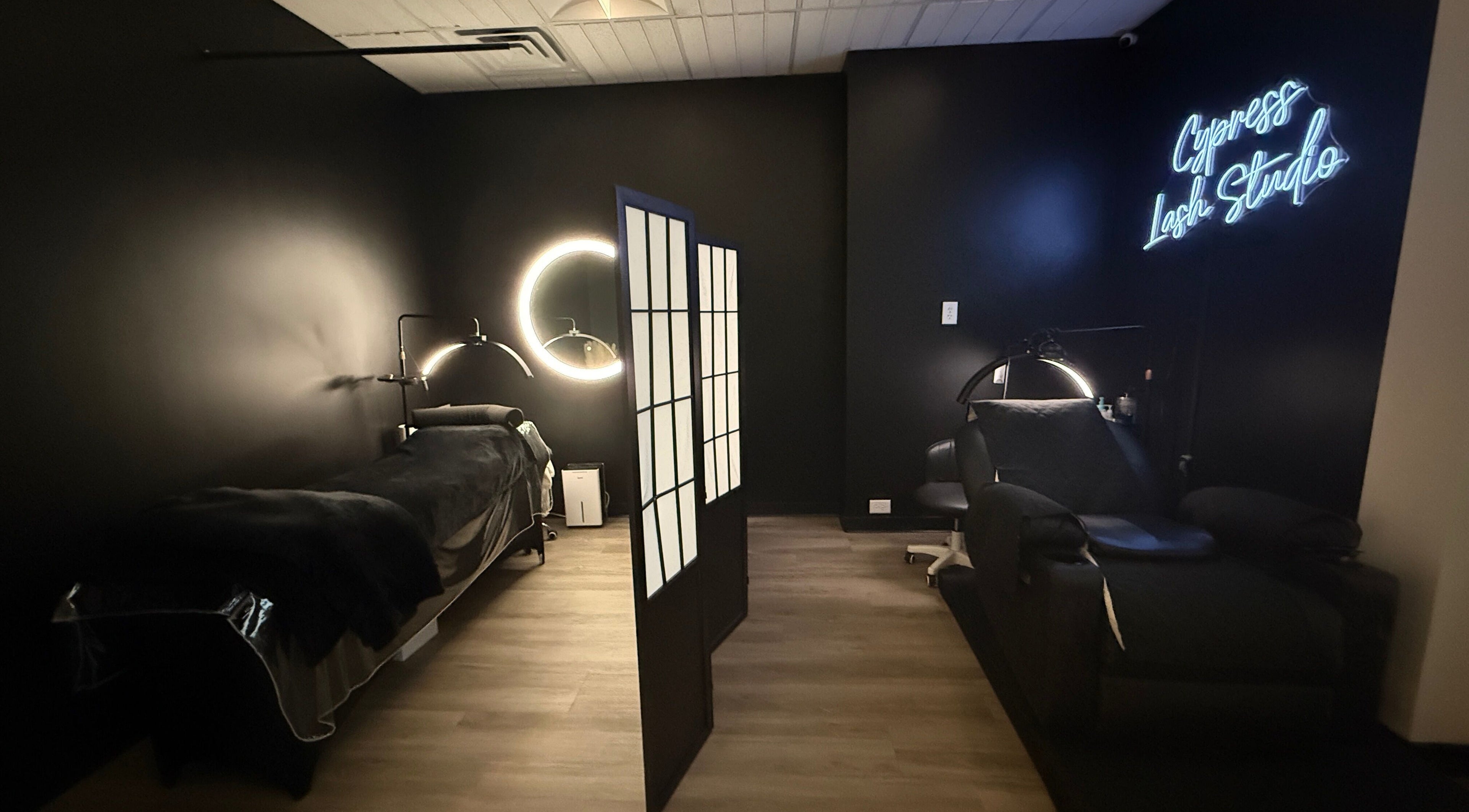 Modern styling room at Cypress Lash Studio, Cypress, Texas, US with neon signage and sleek decor.