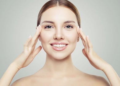 Smiling woman showcasing skincare results at Shape & Glow Aesthetics Birmingham, Birmingham, England, GB.