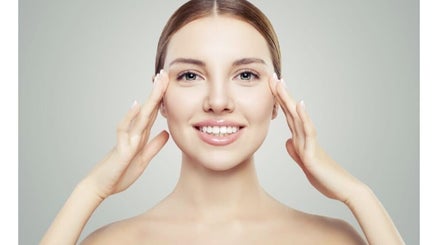 Smiling woman showcasing skincare results at Shape & Glow Aesthetics Birmingham, Birmingham, England, GB.