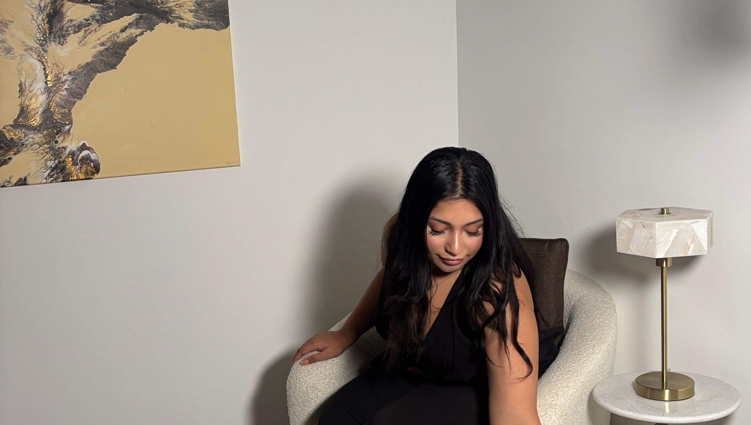 Woman in cozy chair at Created By Leenah, Purfleet, England, GB, highlighting modern decor.