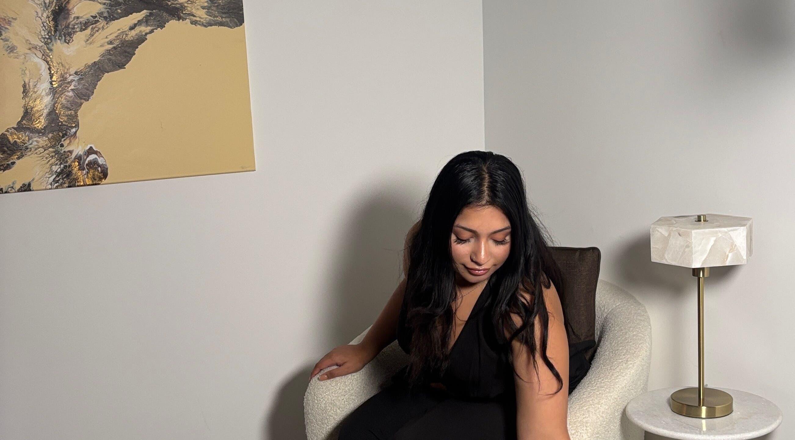 Woman in cozy chair at Created By Leenah, Purfleet, England, GB, highlighting modern decor.