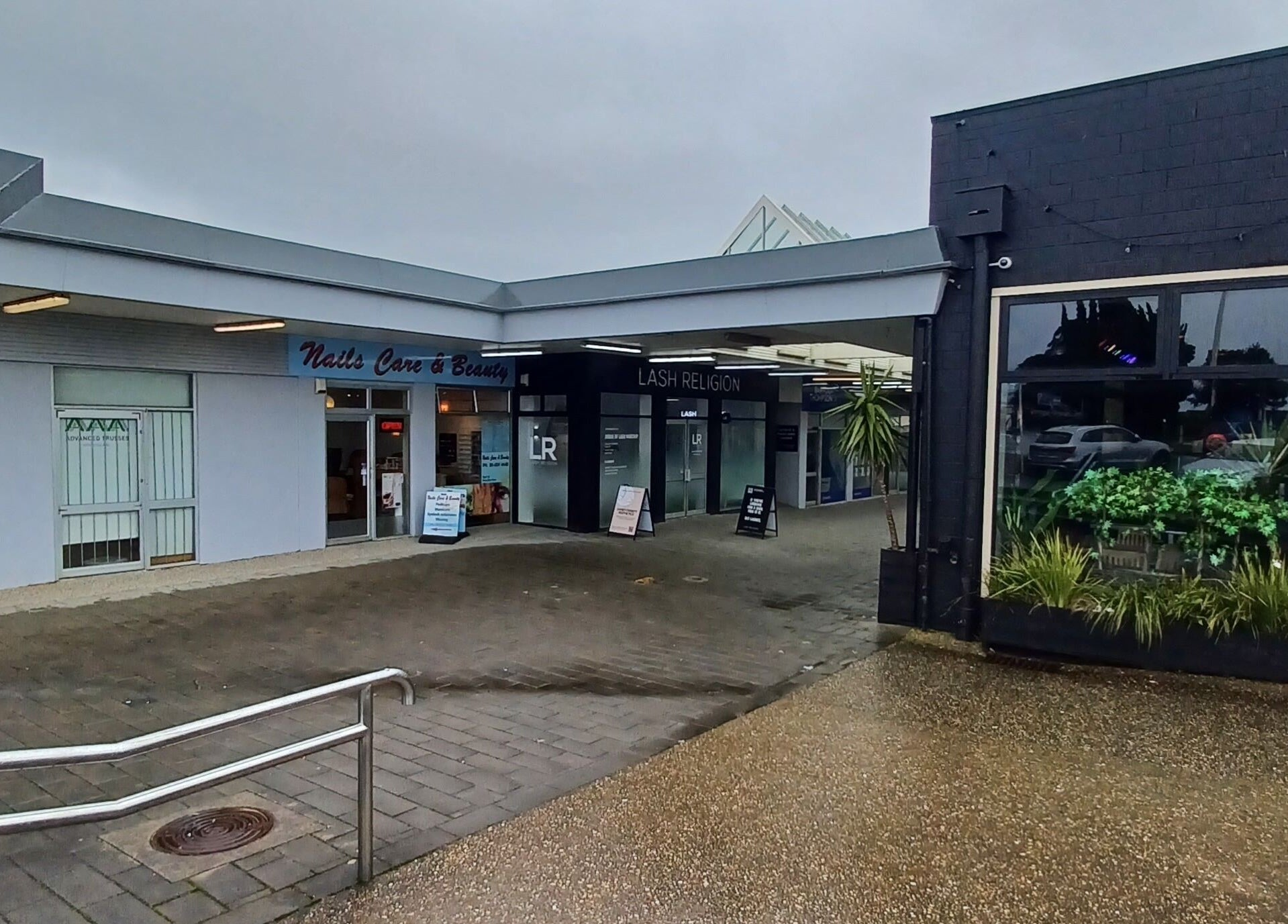 Exterior view of Lainey Everett Aesthetics, Whangaparāoa, Auckland, NZ. Modern facade with signage and landscaping.