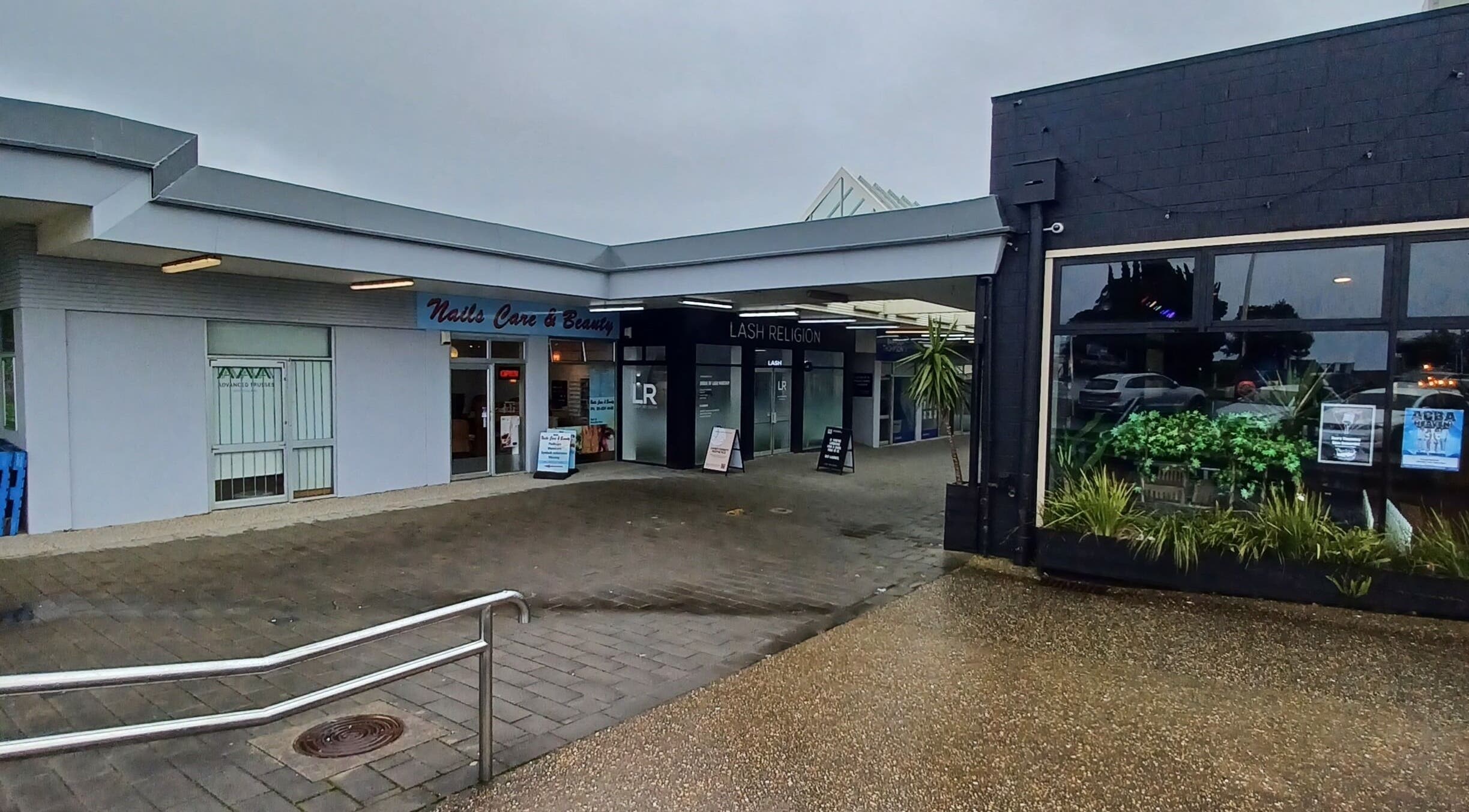 Exterior view of Lainey Everett Aesthetics, Whangaparāoa, Auckland, NZ. Modern facade with signage and landscaping.