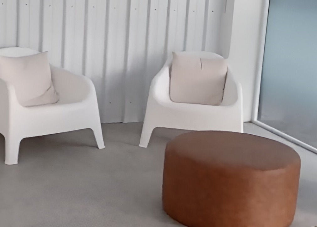 Minimalist lounge chairs in Lainey Everett Aesthetics, Whangaparāoa, Auckland, NZ for relaxation.