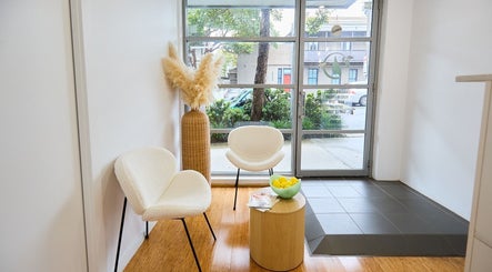 Welcoming seating area at Tone Beauty in Alexandria, New South Wales, AU with modern chairs and natural decor.