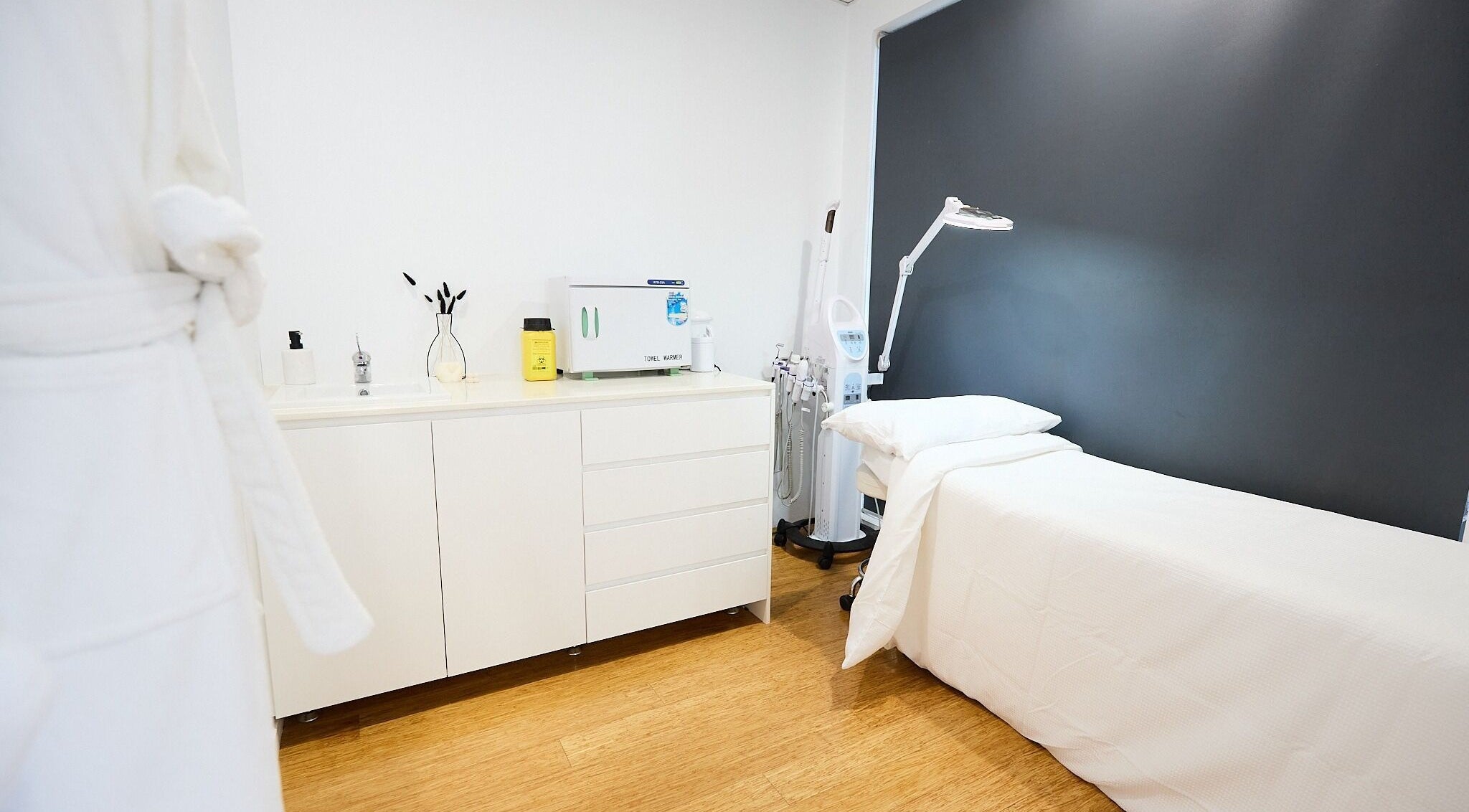 Tranquil treatment room at Tone Beauty in Alexandria, New South Wales, AU with spa bed and equipment.