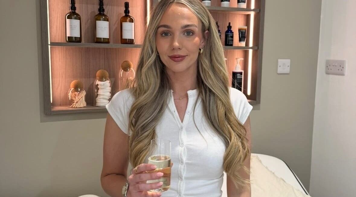 Elegant woman enjoying refreshment at Salon 33 by Ellie, Barrowford, England, GB, showcasing luxury ambiance.