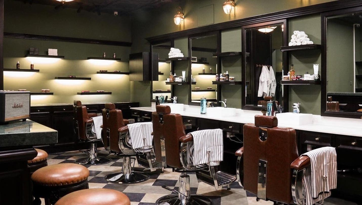 Elegant barbershop interior at Burman Bogalay Zay St, Yangon, Yangon Region, MM, featuring plush leather chairs.