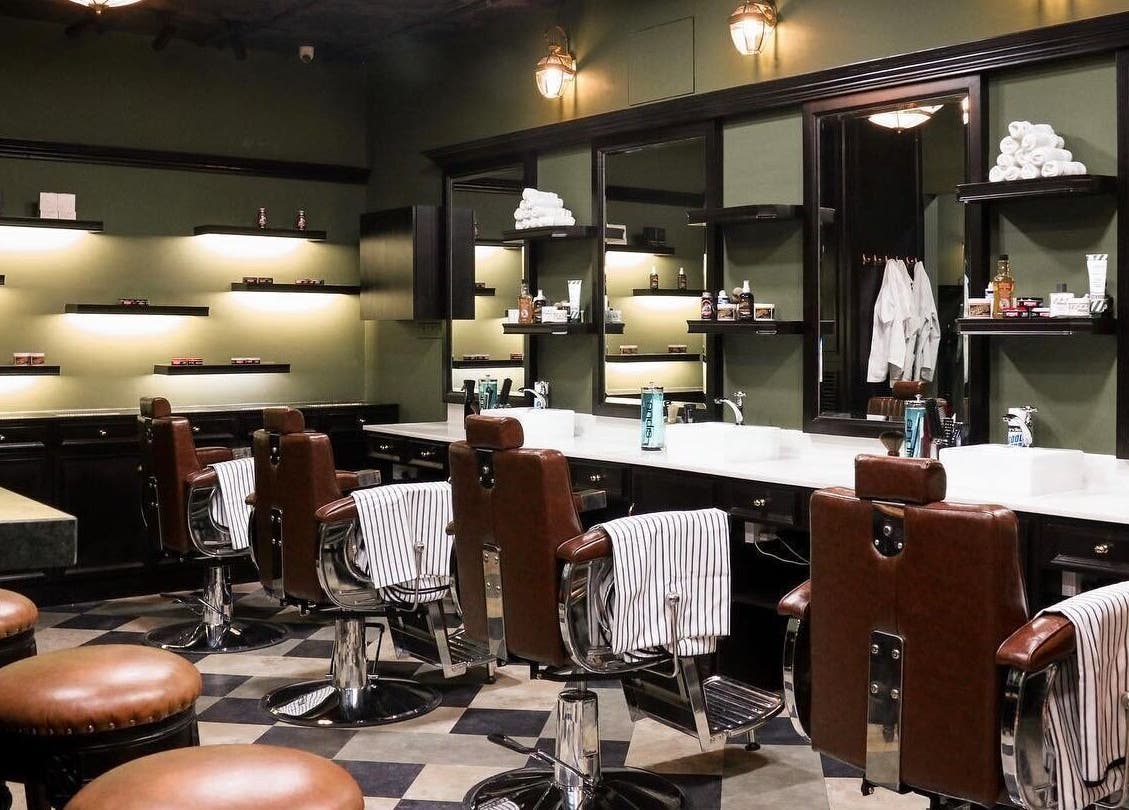 Elegant barbershop interior at Burman Bogalay Zay St, Yangon, Yangon Region, MM, featuring plush leather chairs.