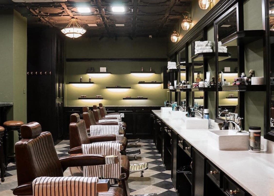 Chic interior of Burman Bogalay Zay St salon, Yangon, featuring stylish barber chairs and modern decor.