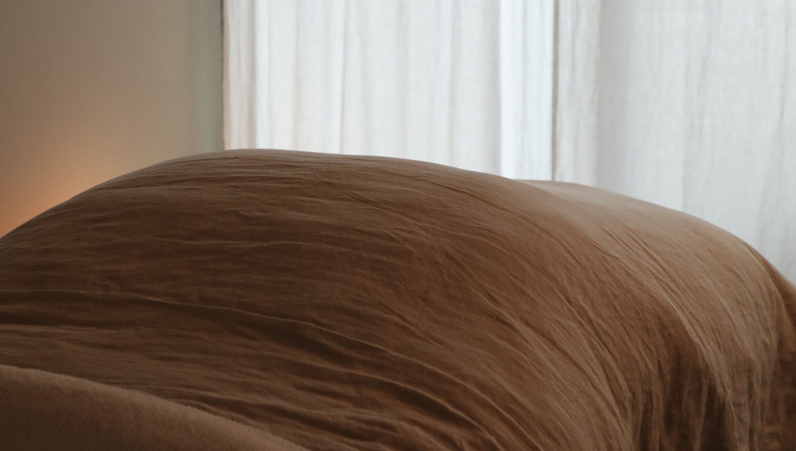 A serene massage table draped in soft linen at Soften MELBOURNE, Prahran, Victoria, AU.