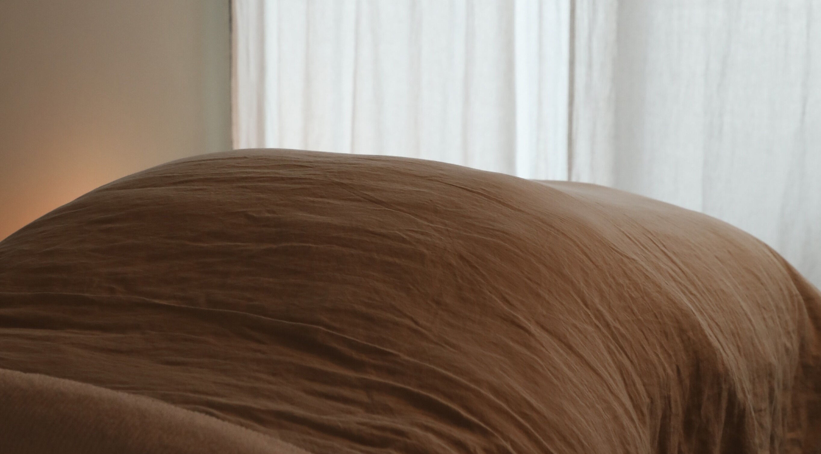 A serene massage table draped in soft linen at Soften MELBOURNE, Prahran, Victoria, AU.