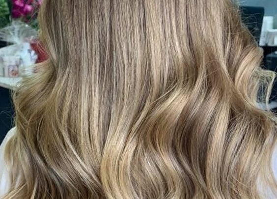 Blonde wavy hairstyle at Tress & Bloom Ystradgynlais, Ystradgynlais, Wales, GB showcasing elegant curls.