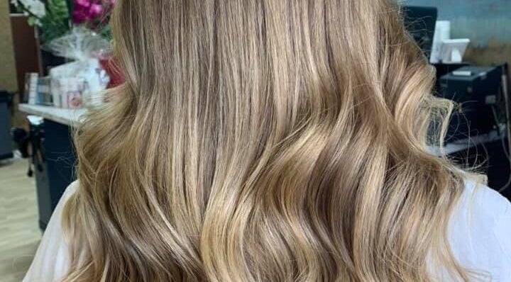 Blonde wavy hairstyle at Tress & Bloom Ystradgynlais, Ystradgynlais, Wales, GB showcasing elegant curls.