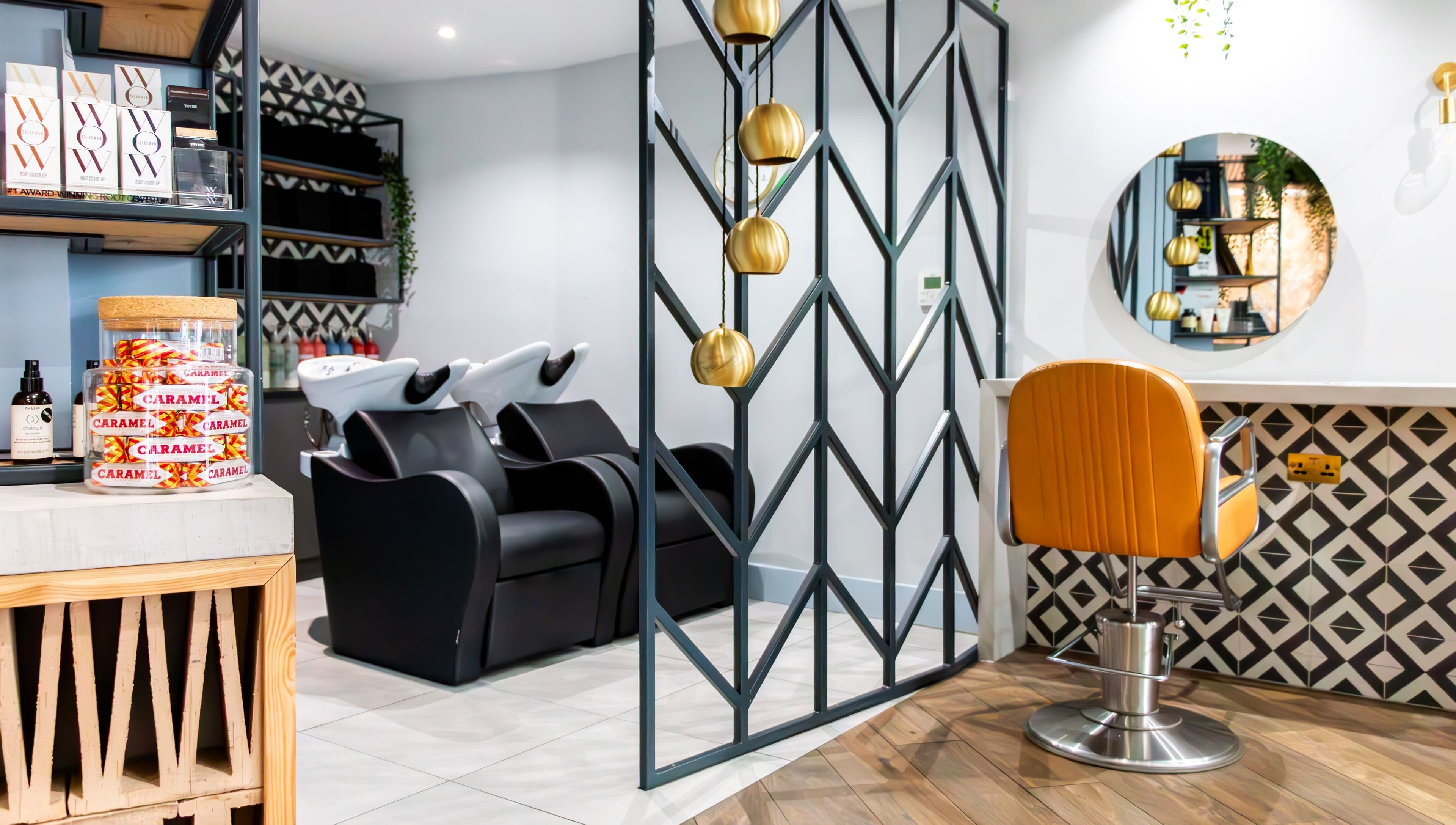 Sleek salon interior at Tribe Academy - Clapham Common, London, England, GB featuring modern decor and styling chairs.