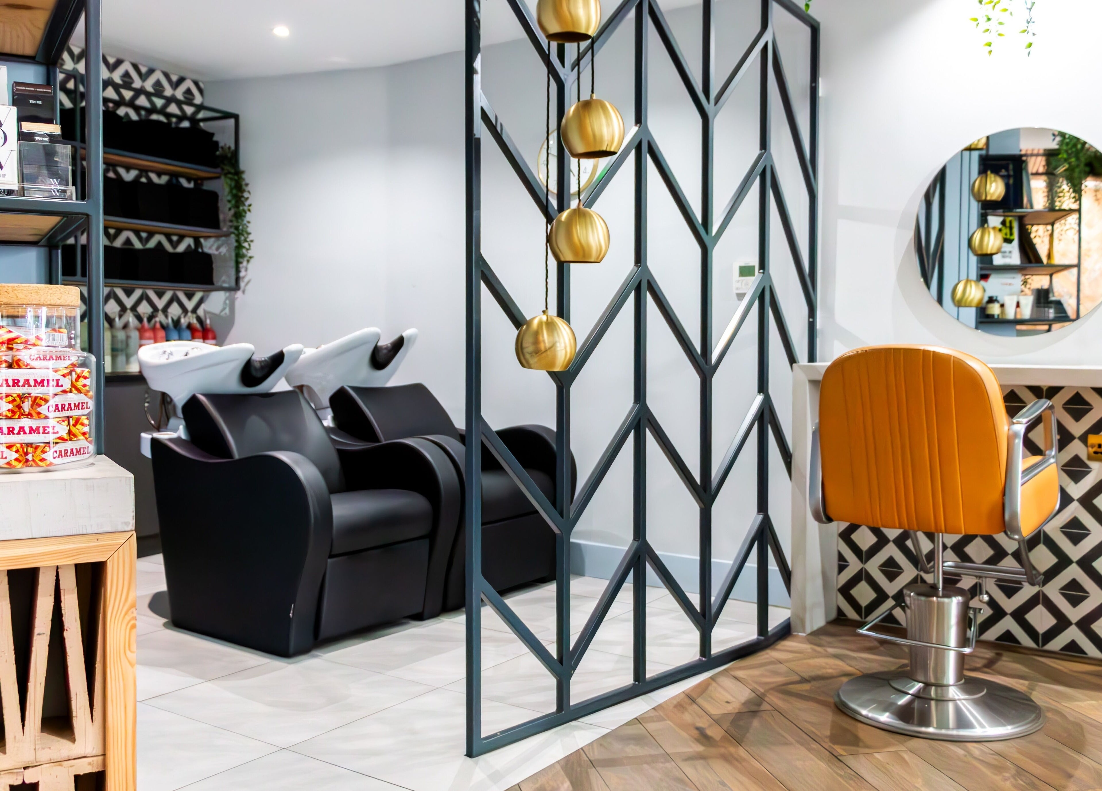 Sleek salon interior at Tribe Academy - Clapham Common, London, England, GB featuring modern decor and styling chairs.