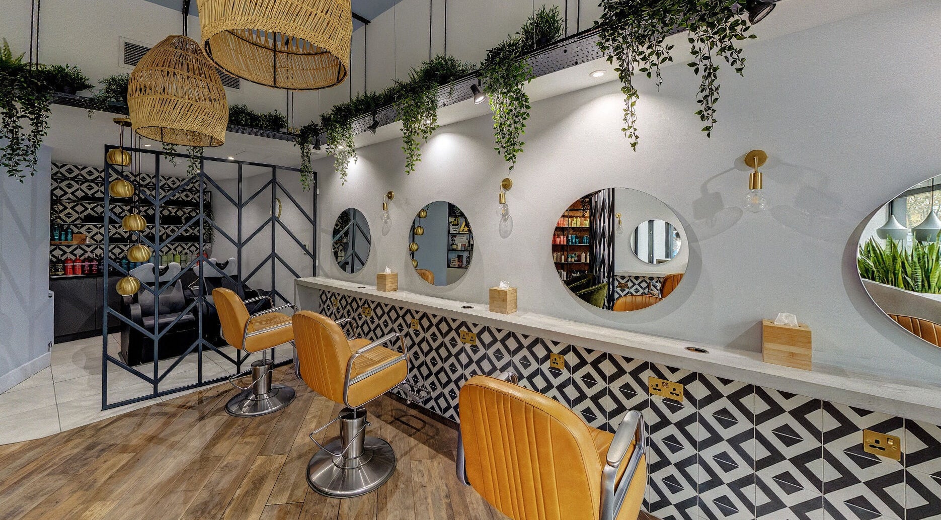 Modern salon interior at Tribe Academy - Clapham Common, featuring chic decor and styling chairs, London, England, GB.