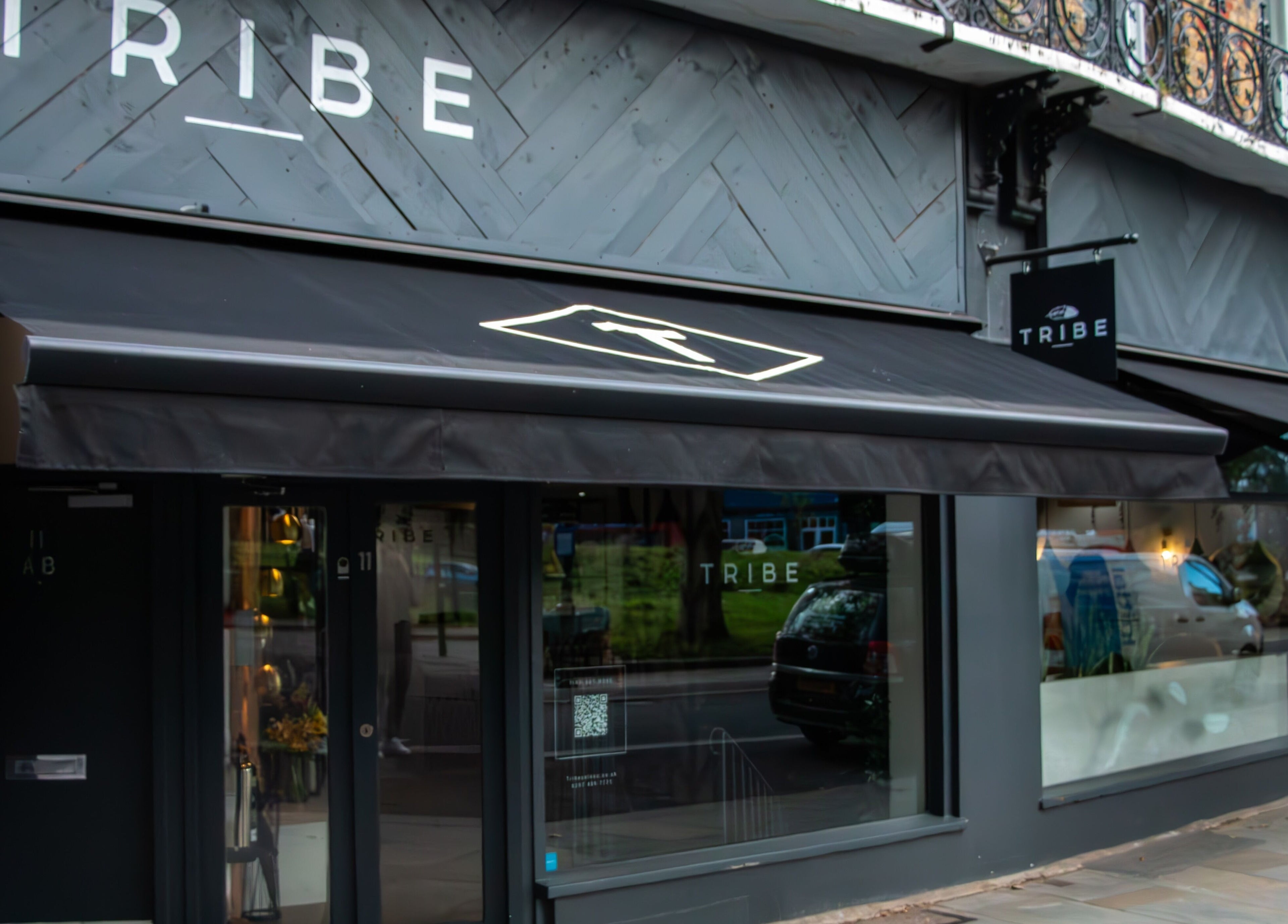 Tribe Academy - Clapham Common exterior in London, England, GB with stylish black awnings.
