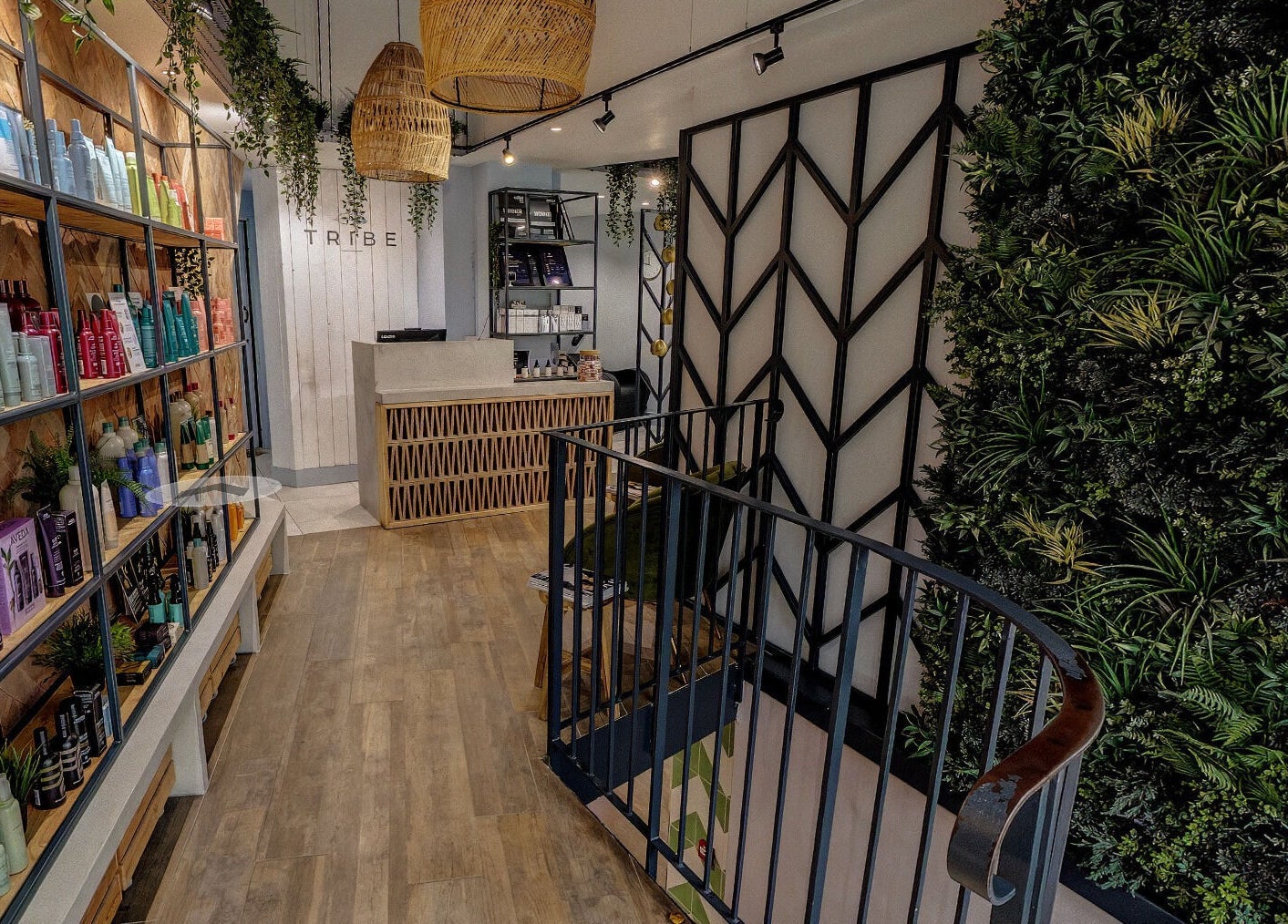 Interior of Tribe Academy - Clapham Common with lush plants and product shelves. London, England, GB.