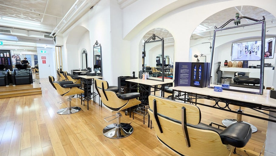 Stylish interior of StyleLab Hair in Sydney, New South Wales, AU, featuring elegant wooden flooring and modern salon chairs.