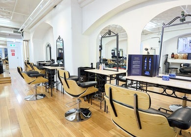 Stylish interior of StyleLab Hair in Sydney, New South Wales, AU, featuring elegant wooden flooring and modern salon chairs.