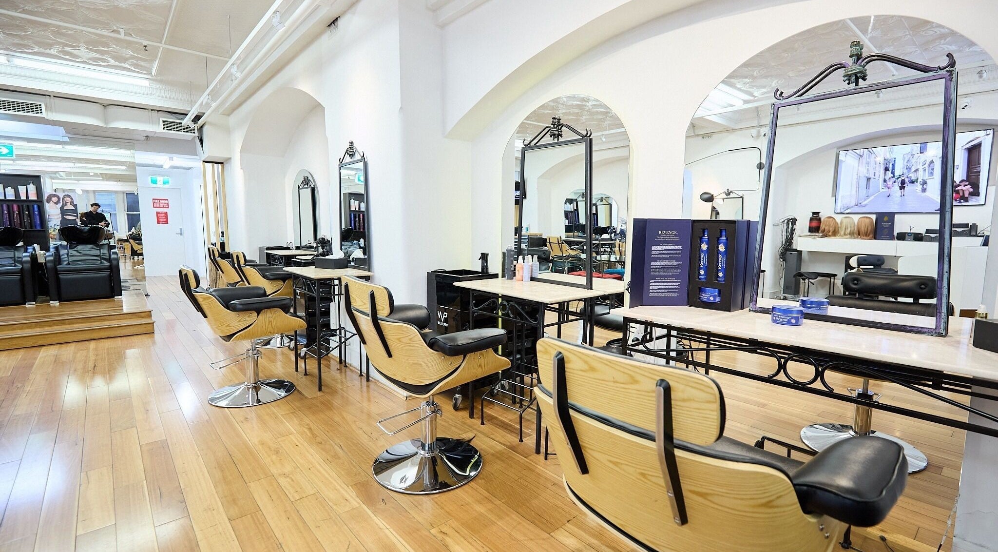 Stylish interior of StyleLab Hair in Sydney, New South Wales, AU, featuring elegant wooden flooring and modern salon chairs.
