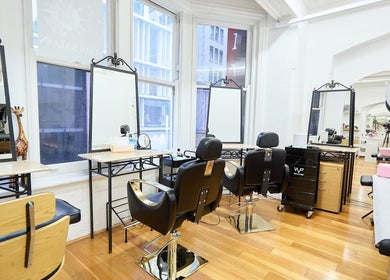 Elegant interior of StyleLab Hair, Sydney, with modern salon chairs and large mirrors.
