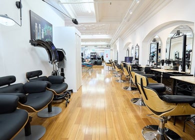 Interior of StyleLab Hair in Sydney, New South Wales, AU, showcasing sleek styling chairs and modern design.