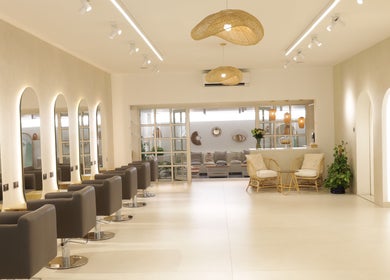 Elegant interior of Essential Beauty Salon in Dubai, Dubai, AE, featuring modern chairs and decor.