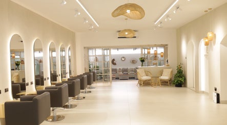 Elegant interior of Essential Beauty Salon in Dubai, Dubai, AE, featuring modern chairs and decor.