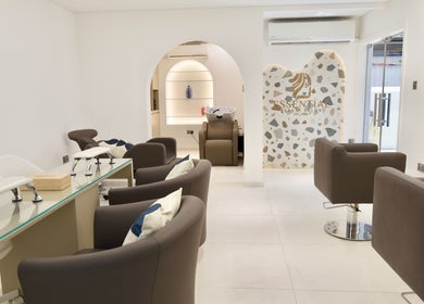 Modern interior of Essential Beauty Salon in Dubai, Dubai, AE, featuring stylish seating and sleek design.