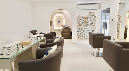 Modern interior of Essential Beauty Salon in Dubai, Dubai, AE, featuring stylish seating and sleek design.