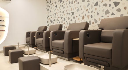 Luxurious pedicure station at Essential Beauty Salon in Dubai, Dubai, AE with modern seating and foot baths.