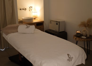 Relaxing treatment room at Essential Beauty Salon, Dubai, Dubai, AE with massage bed and ambient lighting.