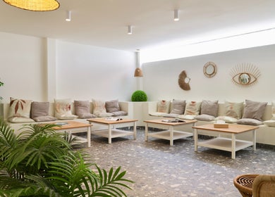 Relaxing seating area with cushions at Essential Beauty Salon, Dubai, Dubai, AE for a serene ambiance.