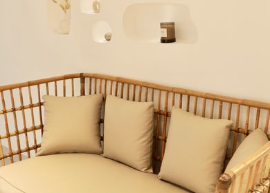 Cozy rattan seating with cushions at Essential Beauty Salon, Dubai, Dubai, AE offering a relaxing atmosphere.