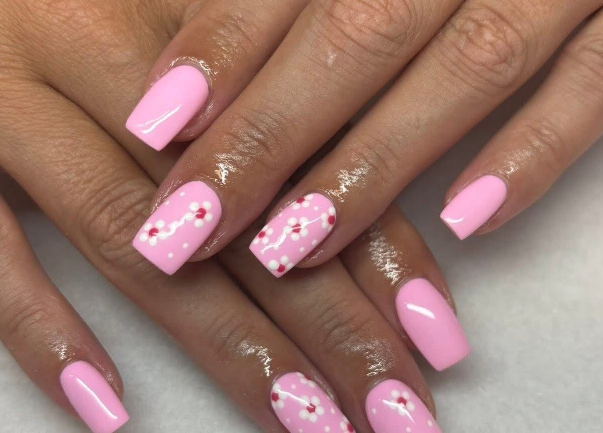 Pink floral nail art at Made Up Salon, Rochester, England, GB showcases delicate blossom designs.