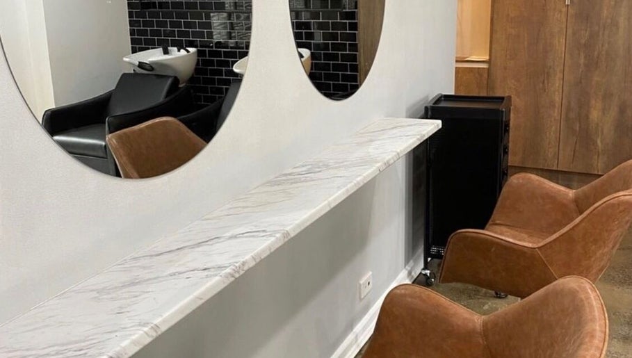 Modern salon seating and mirrors at J Fernandez Hair, Melbourne, Victoria, AU.