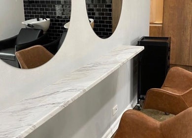 Modern salon seating and mirrors at J Fernandez Hair, Melbourne, Victoria, AU.