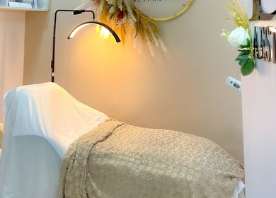 Relaxing treatment room at Beautified By Linda Med Spa & Aesthetic Shop, Lekki, Lagos, NG with plush bed and soft lighting.