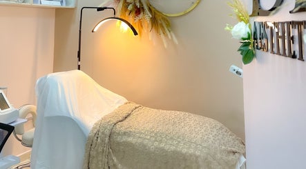 Relaxing treatment room at Beautified By Linda Med Spa & Aesthetic Shop, Lekki, Lagos, NG with plush bed and soft lighting.