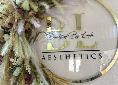 Decorative logo at Beautified By Linda Med Spa & Aesthetic Shop, Lekki, Lagos, NG, with florals.